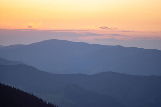 istock Beautiful orange sky during dusk in the carpathian mountains 1325439846