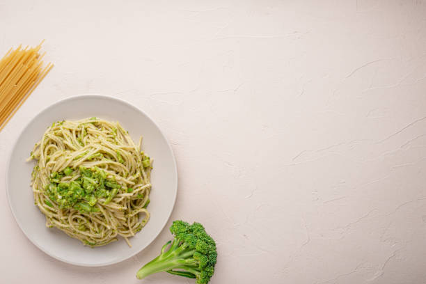 istock Plate of cooked pasta with broccoli top view close up with copy space 1325439883