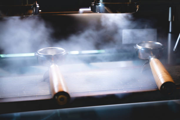 istock professional barista making espresso coffee to a drink cup in cafe, beverage caffeine machine, person pouring hot water with hand, business in the morning breakfast, fresh aroma in hot drink 1325447882