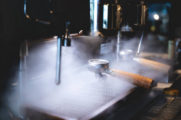 istock professional barista making espresso coffee to a drink cup in cafe, beverage caffeine machine, person pouring hot water with hand, business in the morning breakfast, fresh aroma in hot drink 1325448068