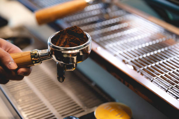 istock professional barista making espresso coffee to a drink cup in cafe, beverage caffeine machine, person pouring hot water with hand, business in the morning breakfast, fresh aroma in hot drink 1325448113