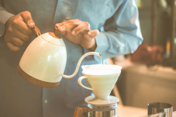 istock professional barista making espresso coffee to a drink cup in cafe, beverage caffeine machine, person pouring hot water with hand, business in the morning breakfast, fresh aroma in hot drink 1325448749