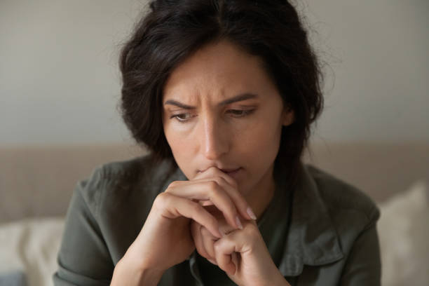 istock Close up of unhappy frustrated woman thinking about problems 1325452763
