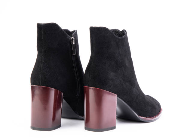 istock Women's autumn ankle suede boots with black zip and red average heels, isolated white background. Back side view. Fashion shoes. shoe shop concept. Concept of fashion and design, shopping 1325457083