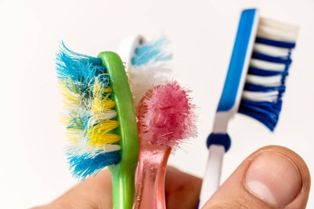 istock Old, spoiled, disheveled, colored toothbrushes in hand 1325457174