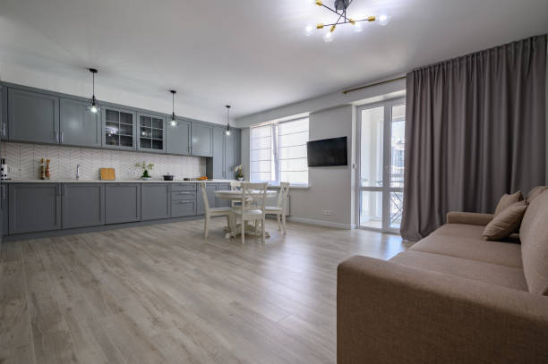 istock Trendy grey and white modern kitchen furniture in studio apartment 1325459554