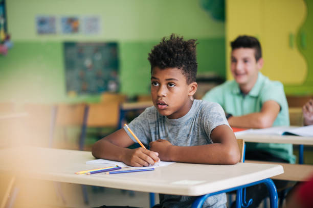 istock Schoolboy listening to lesson. 1325462751