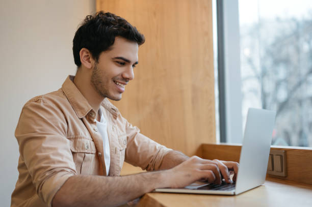 istock Freelancer working from home. Successful asian business man using laptop computer, typing on keyboard, watching training courses, planning start up in office 1325465798