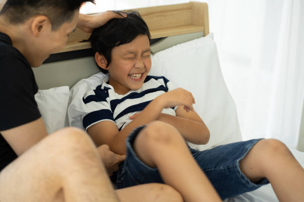 istock Asian father playing with son at home 1325467598