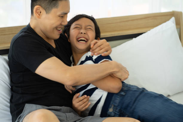 istock Asian father playing with son at home 1325468017