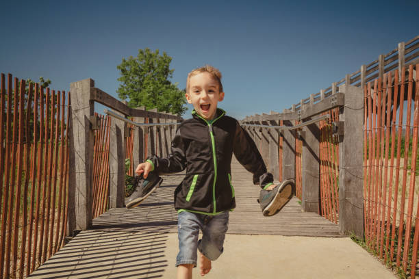 Boy running down a ramp at the Indiana Dunes State Park Bird Observatory.
