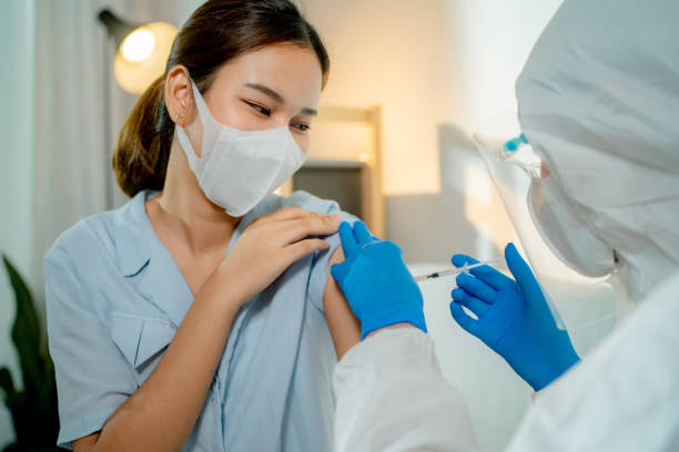 istock Young woman getting covid vaccine. 1325470520