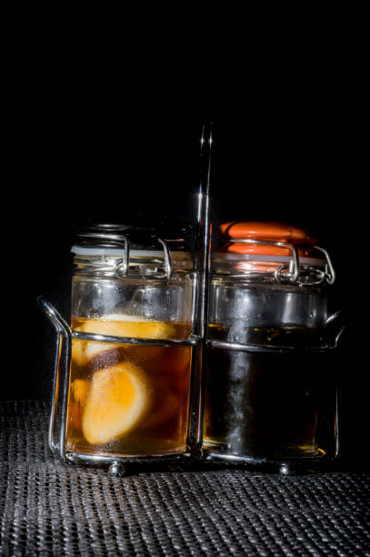 istock garlic being matured in a glass with bee honey on a black background. 1325470773
