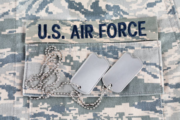 istock US AIR FORCE branch tape and veteran old type dog tags on digital tiger-stripe pattern Airman Battle Uniform 1325470869