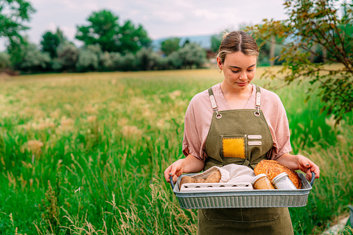 Portrait of a Young Caucasian Woman Holding a Basket of Delicious, Healthy, Organic Produce at a Local Small Business Farm-to-Table Supplier in Colorado