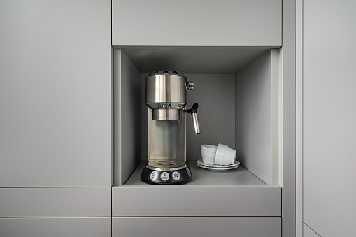 Modern gray kitchen corner with espresso coffee machine, concept photo, lot of copy space