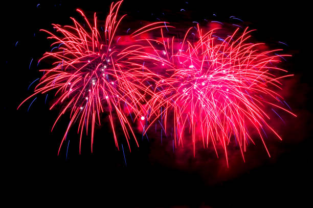 istock Red fireworks fill the night sky around a full moon 1325474150