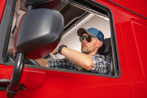 istock Professional Semi Truck Driver Behind the Wheel 1325474796