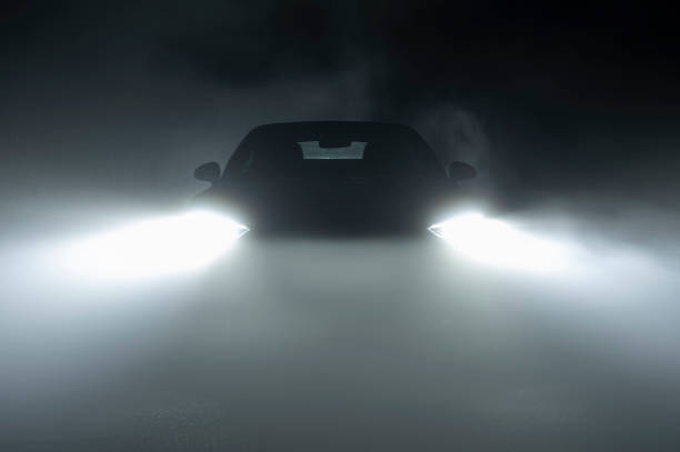 istock Modern LED Car Headlights in Dense Fog 1325476126
