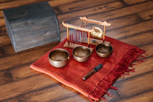 Tibetan handcrafted singing bowls on the floor in yoga class for meditation