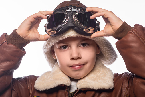 the boy in the jacket of the pilot and in old glasses Aviator. Isolated on white.
