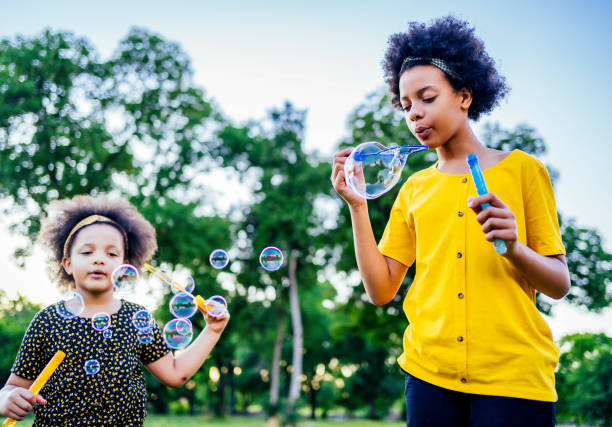 istock Sisters blowing bubbles outdoors 1325485219
