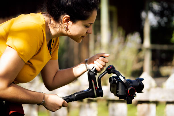 Young hispanic woman holding gimbal while making video outside Young hispanic woman holding gimbal while making video outside. Technological concept black and white portrait photographers stock pictures, royalty-free photos & images
