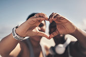 istock Shot of two sporty young women forming a heart shape with their hands 1325486227