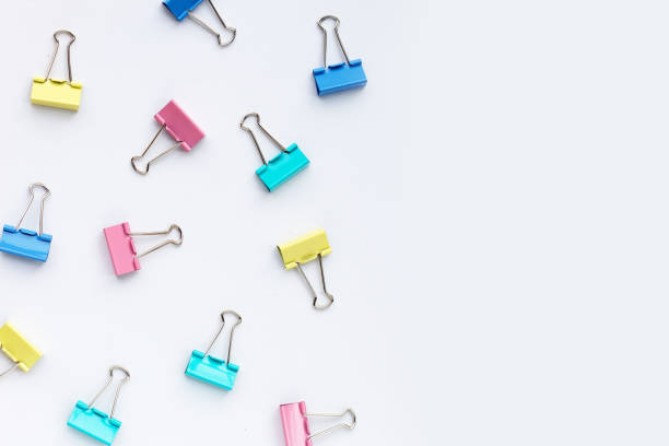 istock Colorful office paper clips on white background. 1325486344