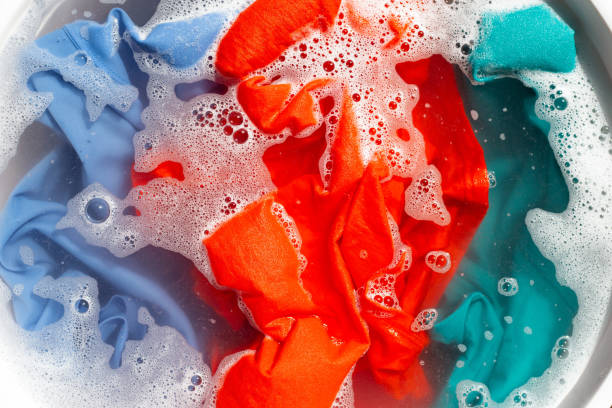 istock Color clothes soak in powder detergent water dissolution. Laundry concept 1325486653