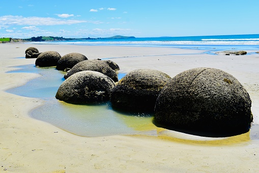 Balancing stones on the seashore at sunset