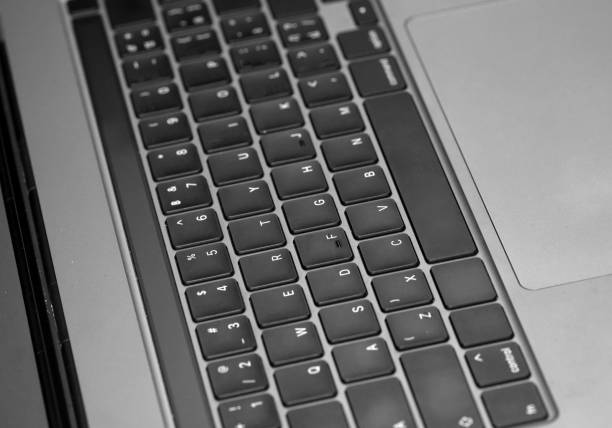 istock Close-up of gray keyboard, part of hardware device, selective focus 1325505103