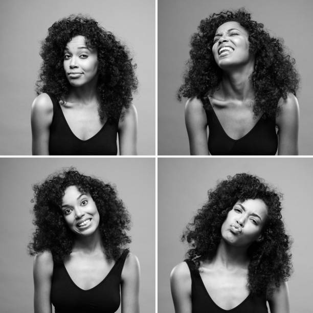 schöne afroamerikanische frau machen lustige gesichter über grauen hintergrund - humor human face women grimacing stock-fotos und bilder