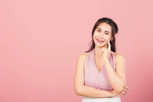 istock woman smiling standing chin handle relaxed thinking about something about the question 1325509928