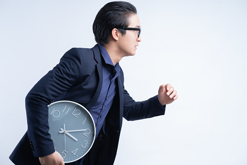 Portrait of Asian businessman holding watch