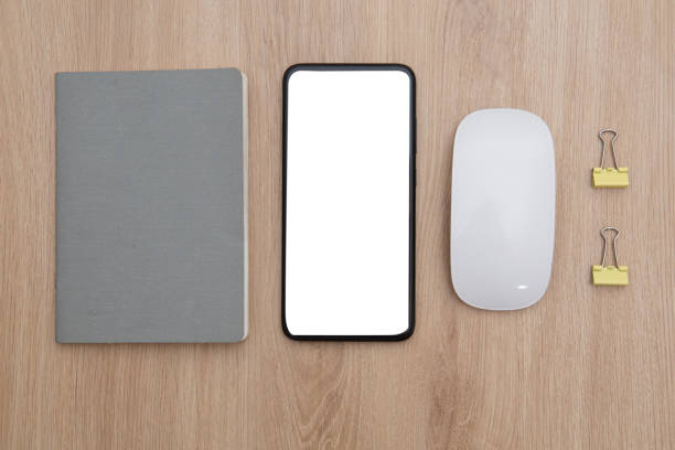 istock Business concept. Flat lay. Top view of notebook, smartphone and wireless mouse on the table 1325514317