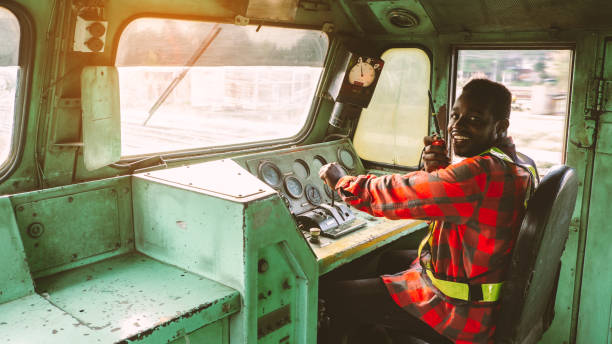 African train driver talking radio communication or walkie talkie in  interior room to control place of train African train driver talking radio communication or walkie talkie in  interior room to control place of train transport conductor stock pictures, royalty-free photos & images