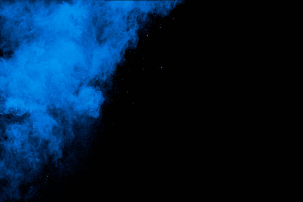 istock Abstract Blue Pink colored sand splash against  black background. 1325517341