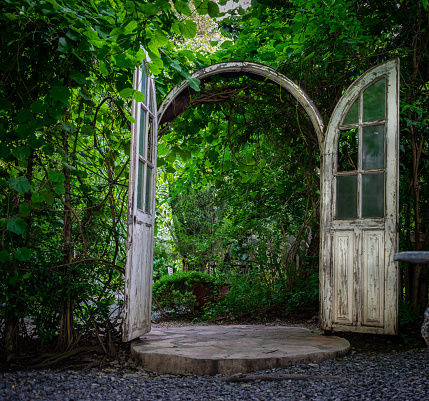 garden door, vintage style, white wooden structure around with plant and tree