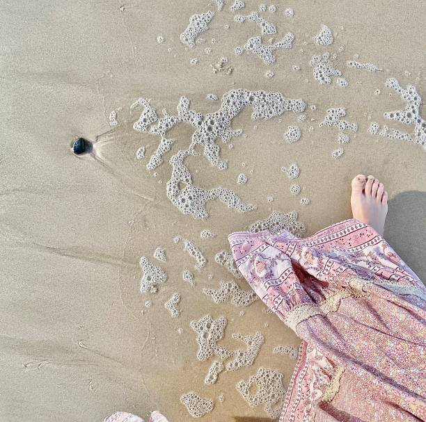 istock Barefoot Walk on Beach in Long Dress 1325523965