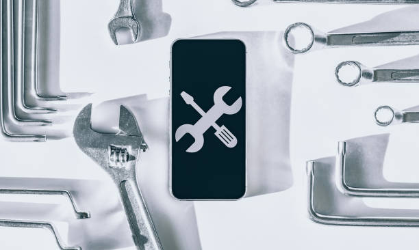 istock Mobile repair service. Technician workplace with phone and special repairing tools. Electronics repair service, device production concept. 1325524225