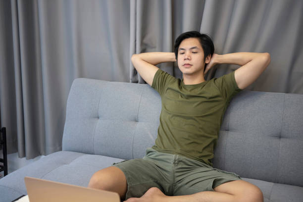 istock Peaceful man resting on couch at home. 1325525756