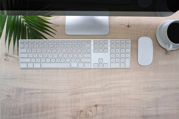 istock Above view modern workspace with computer and coffee cup on wooden desk. 1325525833
