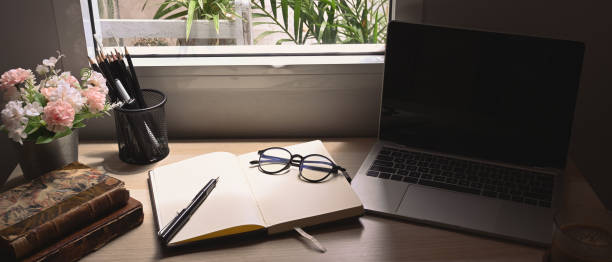 istock Laptop computer, notebook, glasses and books on contemporary workplace. 1325525834