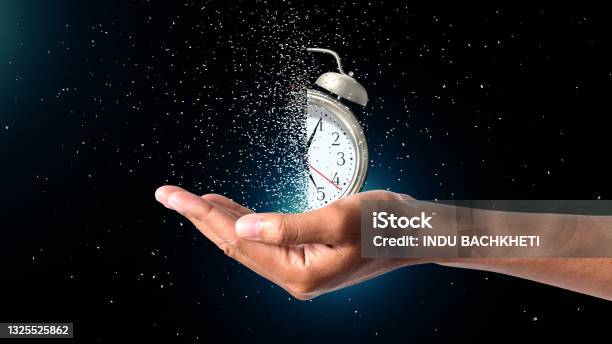 Clock Dispersing In Hand Stock Photo - Download Image Now - Time, Urgency, Countdown
