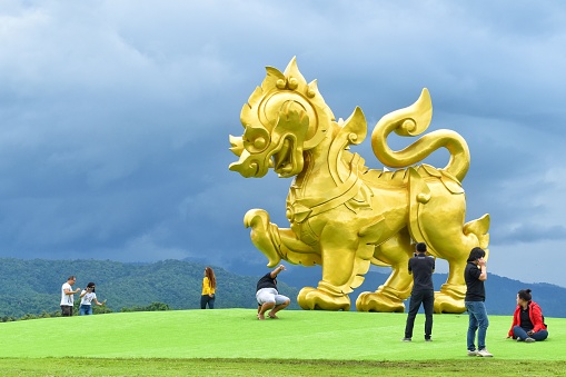 Chiang Rai, THAILAND - 11 August 2018 : Singha or Golden Lion statue at Singha Park in Boonrawd farm. This place is a popular tourist spot to take pictures.