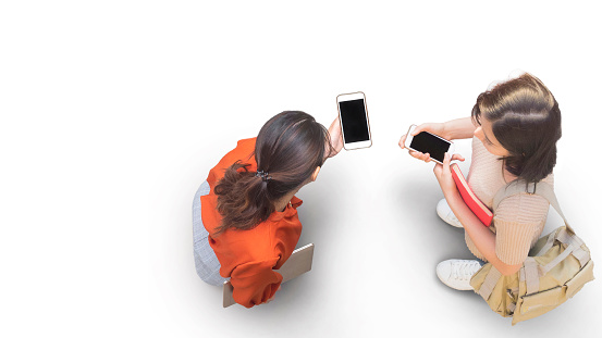 Aerial top view with two student women with smartphone stand at white pavement street with empty space. People life in Social distance.