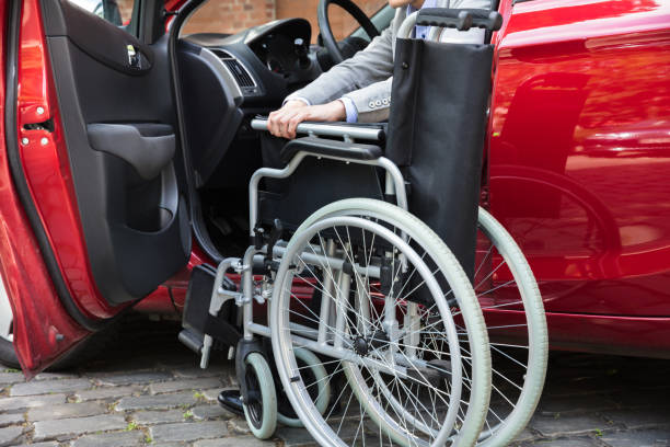 istock Man Sitting In Car Folding His Wheelchair 1325529780