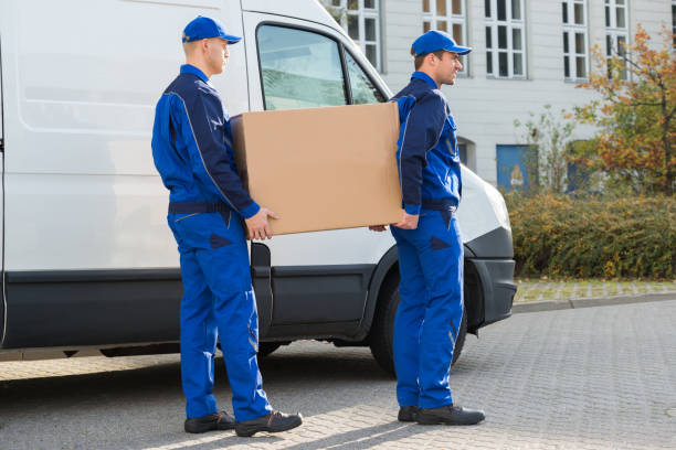 istock Delivery Men Carrying Cardboard Box By Truck 1325529788