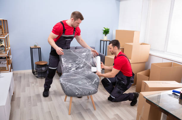 Men Packing The Chair With Plastic stock photo